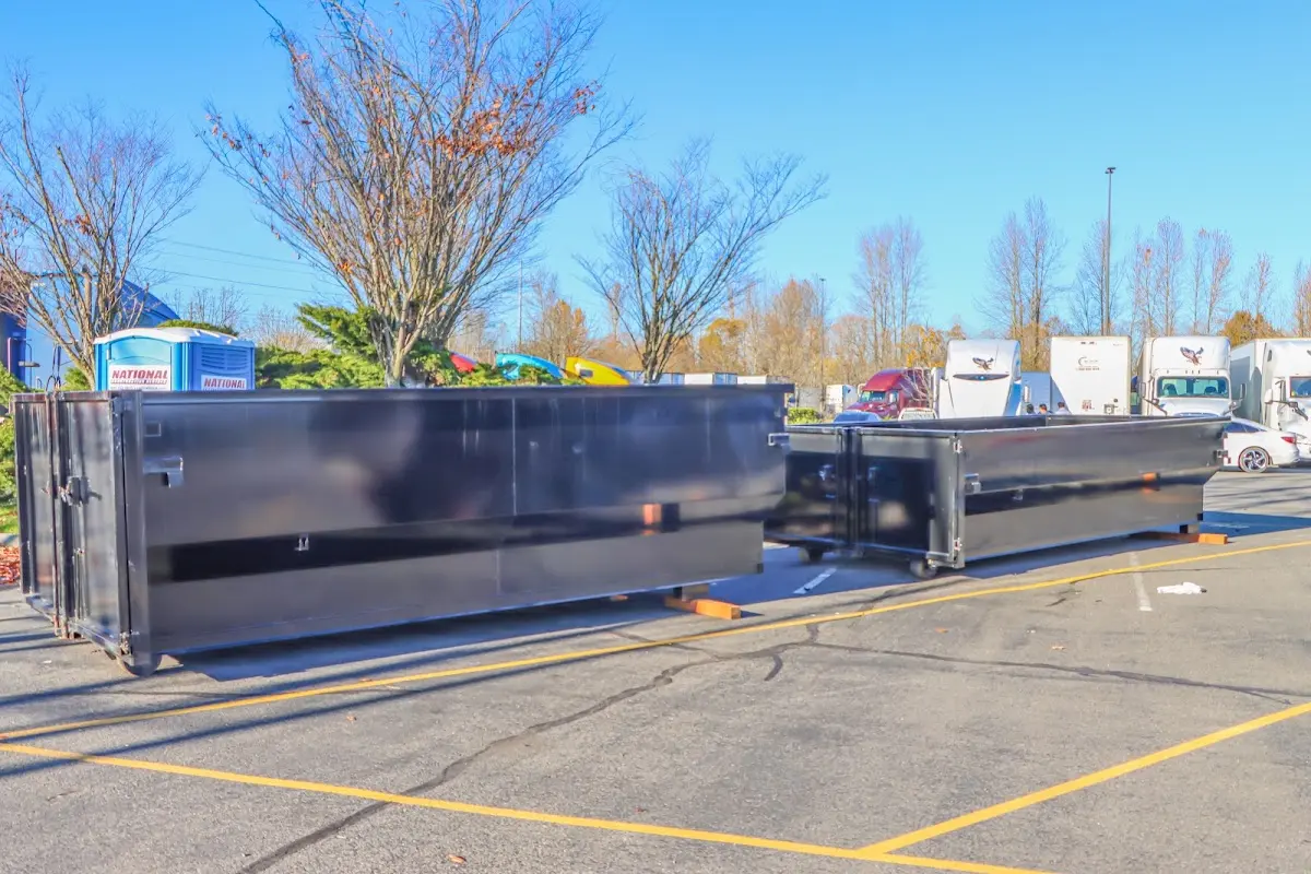 Professional dumpster rental service with roll-off container on residential driveway in Beebe